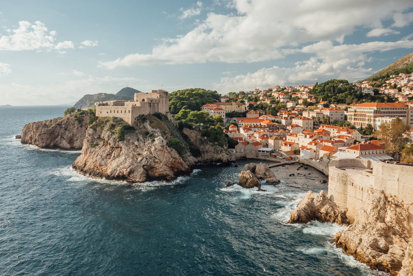 Fortress walls and headlands along a rocky coastline.