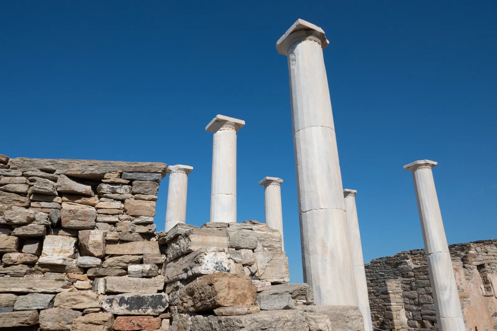 Standing marble columns among ruined stone walls.