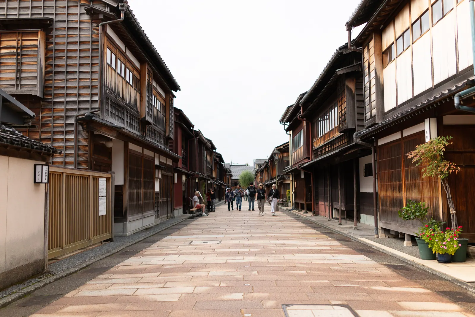 A wide stone street between old wooden teahouses.