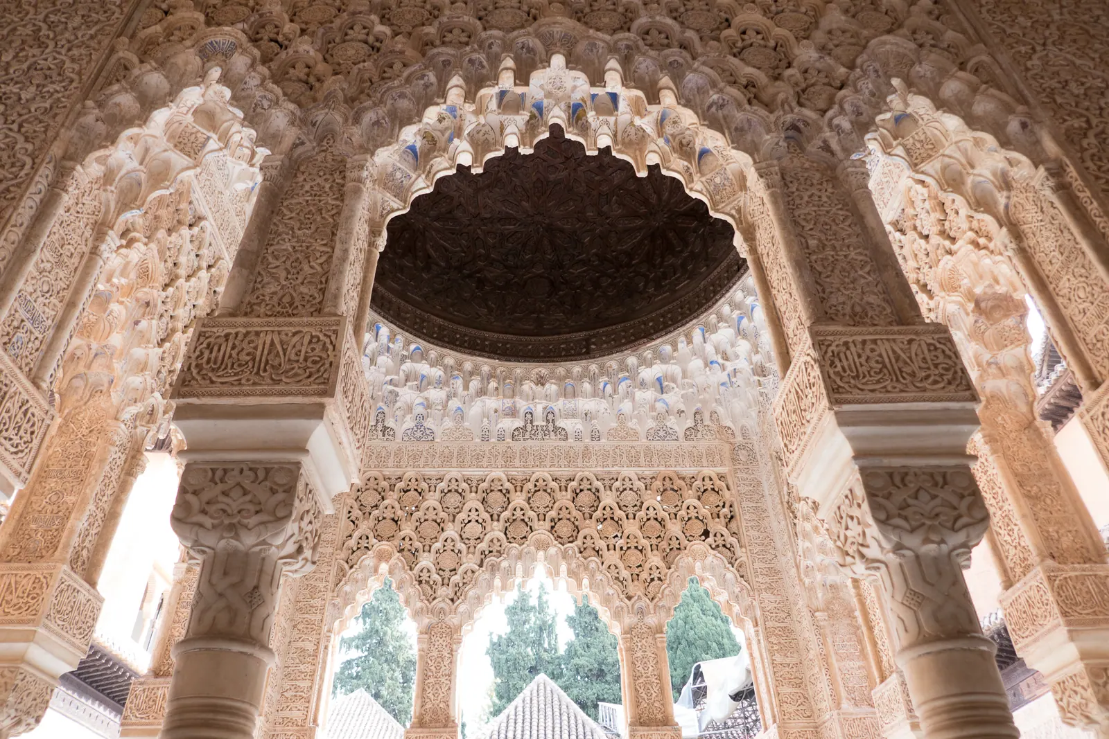 Carved stucco arches and a ceiling of honeycomb vaulting.